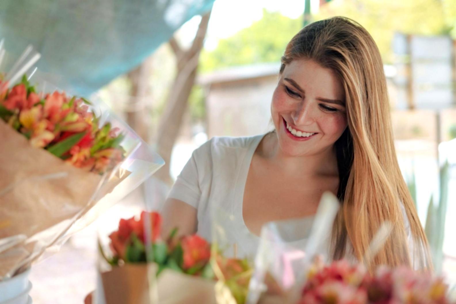Students practicing floral arrangement techniques in workshop setting